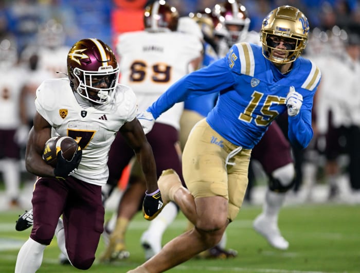 Arizona State Sun Devils wide receiver Melquan Stovall (7) runs against UCLA Bruins defensive lineman Laiatu Latu (15) at the Rose Bowl.